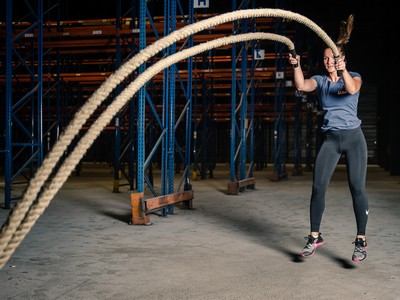 Femme en train de s'entraîner avec une corde ondulatoire LEVEL addict